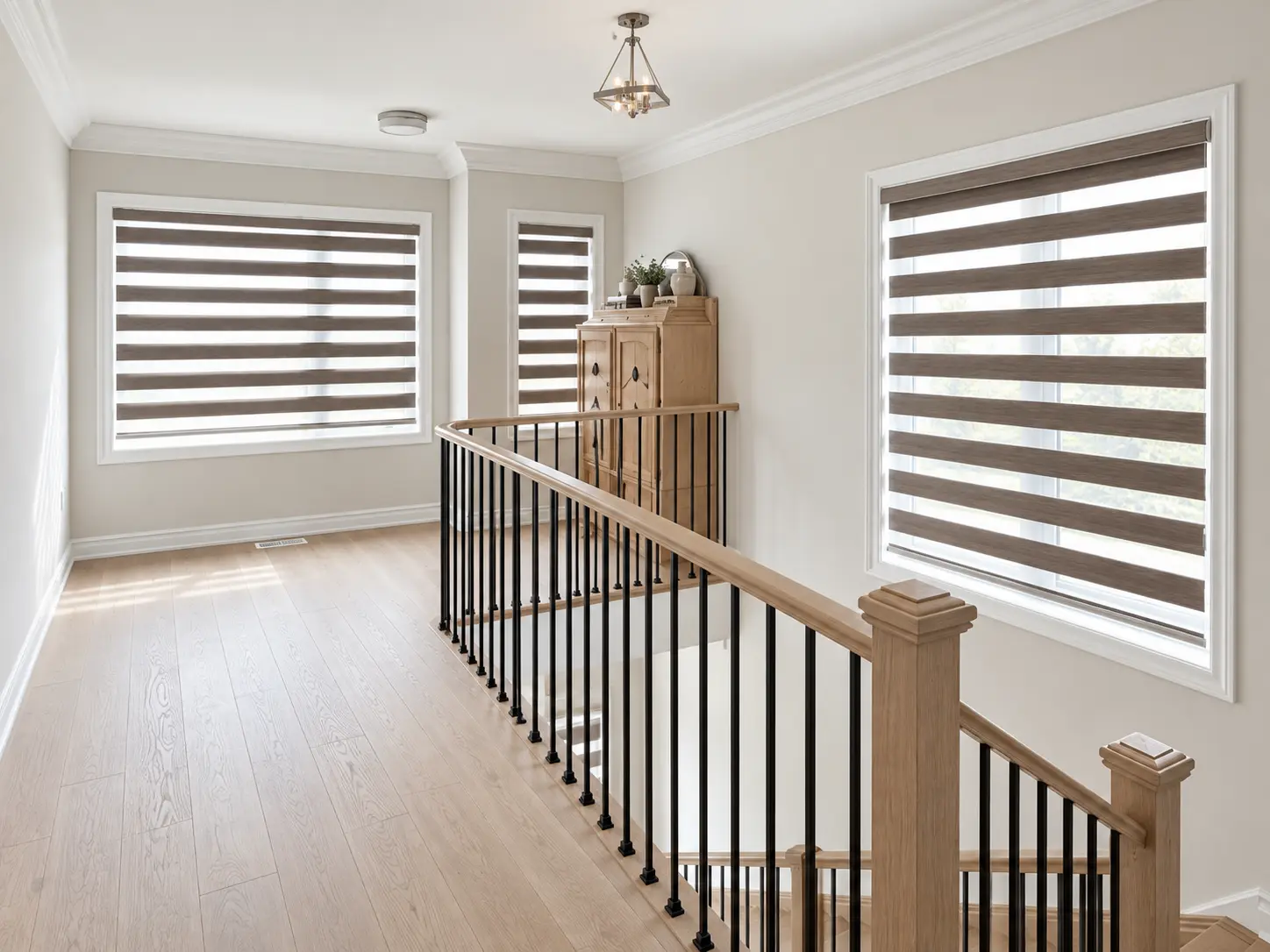 Brown zebra shades on upstairs hallway windows above a staircase